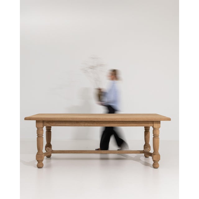 A charming Provençal-style dining table crafted from oak, reflecting the rustic elegance of the French countryside. The...