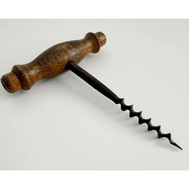 Wonderful antique French cork screw with wood handle and steel screw, both with lovely aged patina. Unmarked.