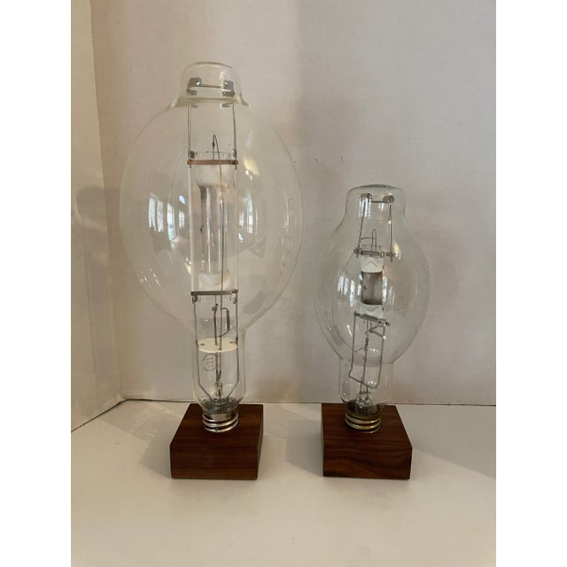 Transparent Vintage Retro High Pressure Sodium Industrial Bulb Display on Wood Pedestal Marked "Roost" - Set of 2 For Sale - Image 8 of 8