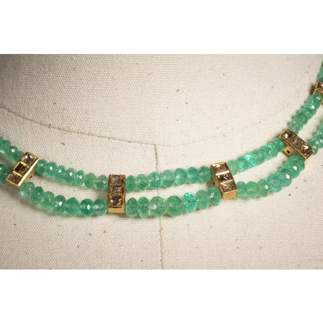 Two rows of faceted Colombian emerald beads comprise this necklace with 22K gold spacers with rosecut diamonds and rosecut...