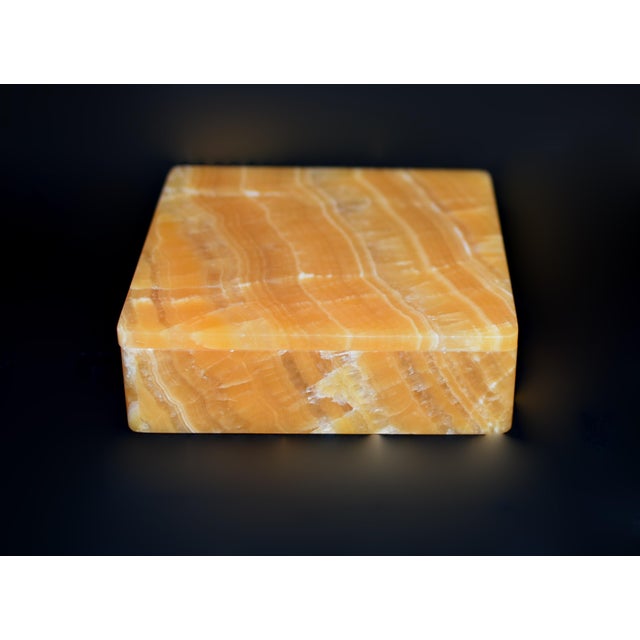 An extraordinary handcrafted onyx box of impressive scale and substantial weight, measuring 4" square and weighing an...