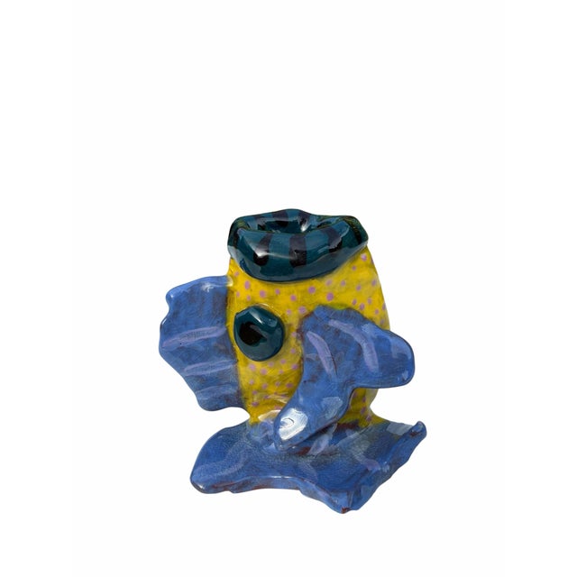 A handcrafted art pottery vase in the form of a tropical fish, finished with a richly developed crackle glaze in shades of...