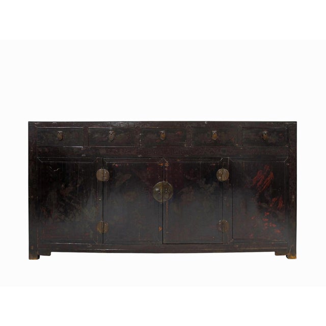 Dating to circa 1846, this large antique Chinese sideboard has a deep red-brown hue, a beautifully aged surface, and an...