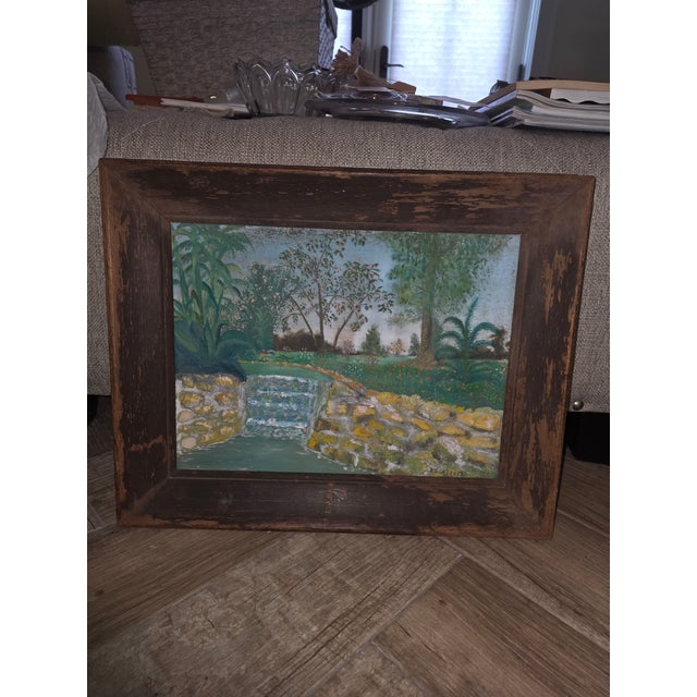 Unusual naive style folk art paintings of a creek or river with almost three dimensional details. The frame is worn and...