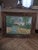 Unusual naive style folk art paintings of a creek or river with almost three dimensional details. The frame is worn and...