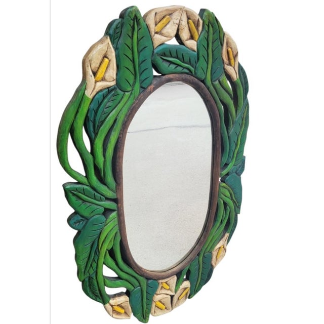 A wonderful tropical brightly colored carved wood wall mirror. The mirror features a fun tropical cala lily and green leaf...