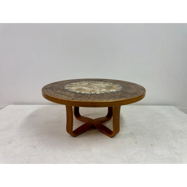 Danish Ceramic Tile-Top Coffee Table, 1980s Round Danish coffee table featuring a richly patterned ceramic tile top set...