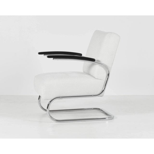 Elegant and exceptionally comfortable cantilever armchair manufactured by Mücke & Melder under a Thonet licence. A...