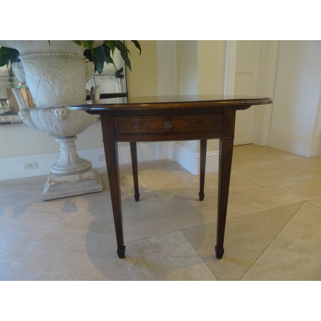 A fabulous Inlaid Pembroke Table with multiple wood species and inlays. With incredible fluted legs and spade feet for...