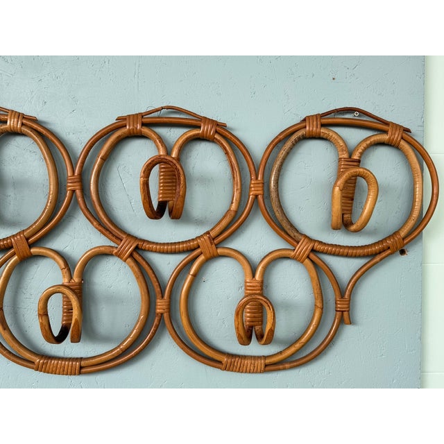 A large, decorative wall-mounted hat rack with seven hooks, from the 1960s. Handcrafted in Italy from bamboo and wicker.