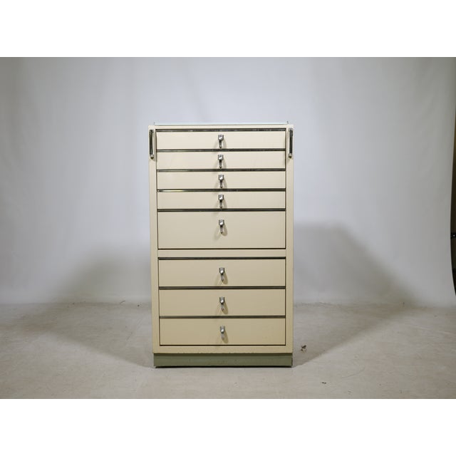 Baisch metal dental cabinet with multiple drawers and chrome handles. A functionally designed piece of furniture with a...