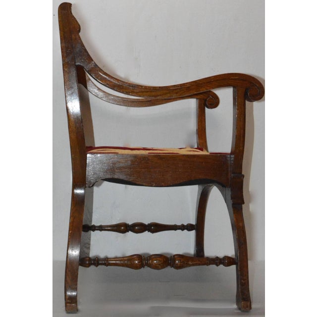 We are offering a wood and fabric chair from the 19th century. It has an intricate inlay design on the back of the chair...