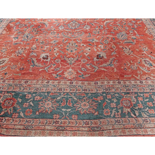 An early 20th century Persian Sultanabad rug, the red field with a finely-drawn floral, leafy palmettes and flowering...