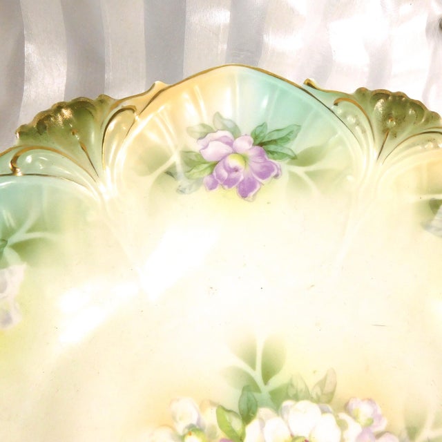 This is a large green Reinhold Schlegelmilch RS Prussia serving bowl with purple flowers and a shaped rim. It has the red...