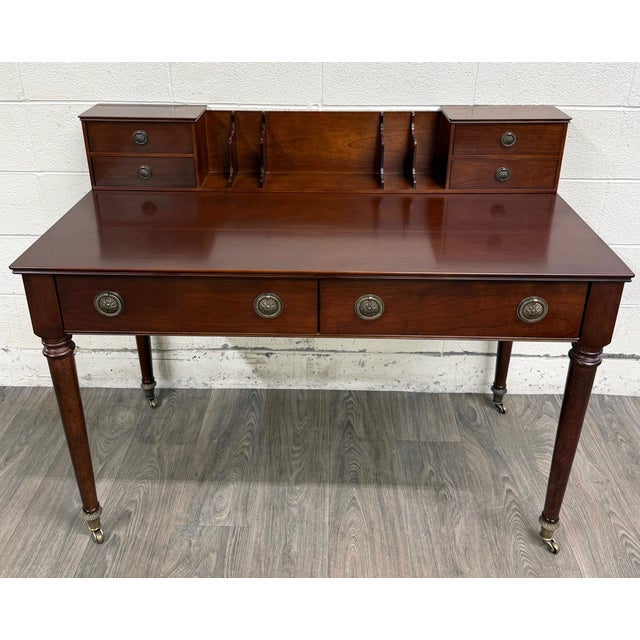 This is a vintage English or Georgian Revival style Bombay Company mahogany writing desk with upper gallery organizer,...