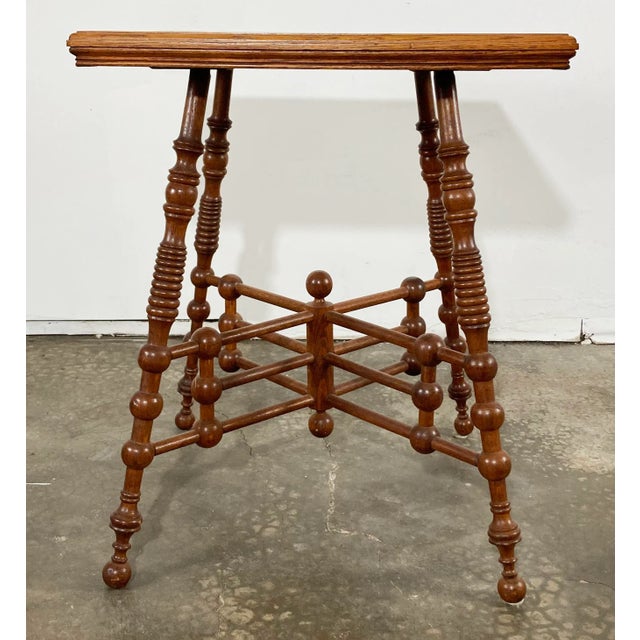 Antique ball and stick table in rich natural finish. Table features a square top with a stunning base with four turned...