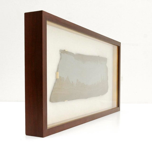 A pietra paesina stone plaque revealing a striking natural landscape, where mineral veining evokes architectural profiles...