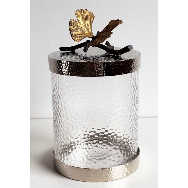 Stunning vintage lidded jar in original box by the well known designer, Michael Aram! It features a lovely gold ginkgo...