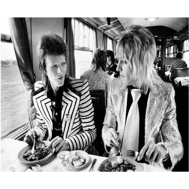 Bowie Eating Lunch - Limited Edition Mick Rock Estate Print David Bowie and Mick Ronson eating lunch on a train to...