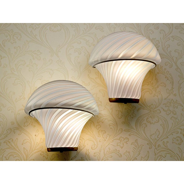 Add a touch of retro elegance and exclusivity to your spaces with this pair of Murano glass wall sconces. Featuring an...