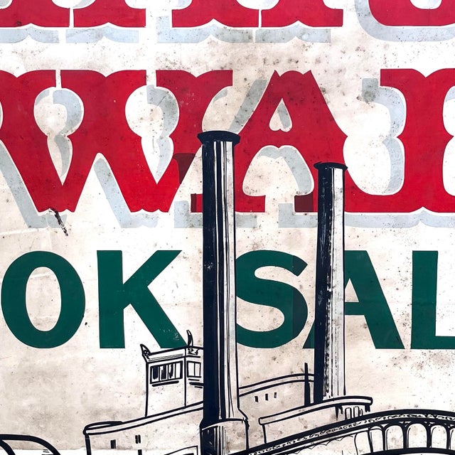 A large, eye-catching painted trade sign on wood board with the text "Mark Twain Book Sales" along with steamboat imagery....