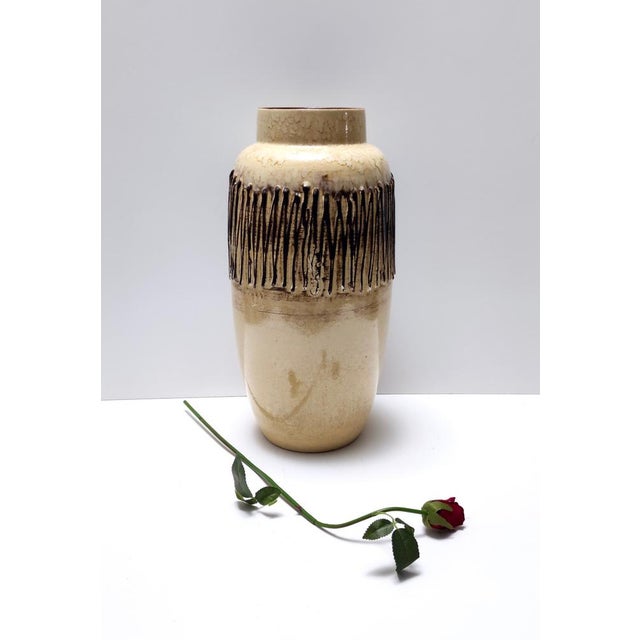 Made in Germany, 1970s. This handmade vase is made in glazed ceramic. It is a vintage piece, therefore it might show...