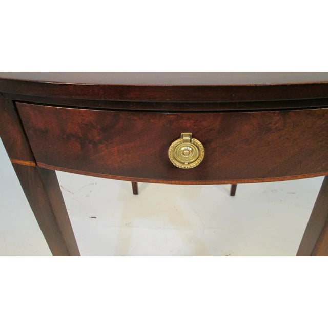 This is a very nice mahogany Pembroke table made by Beacon Hill. The top is a figured mahogany with a small satin wood...