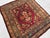 This antique hand-knotted Akstafa rug features a bold serrated diamond medallion in deep red and chocolate brown, framed...