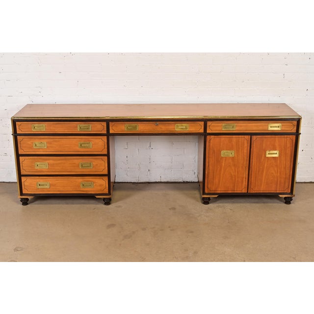A gorgeous mid-century modern Hollywood Regency Campaign style desk or executive credenza By Baker Furniture USA, Circa...