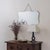 Stunning Art Deco mirror from France, 1930s. Beveled mirror secured to a wooden back. Mirror hangs from vintage metal...