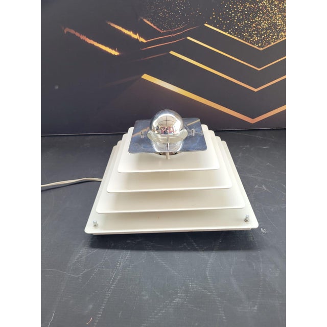 Wall or ceiling lamp with stepped structure produced by Egoluce in the 70s. Thanks to the various holes on the back it can...