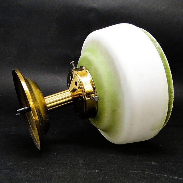 The pendant lamp was produced in the 50s. It is made in the art deco style. The construction is brass, glass lampshade. It...