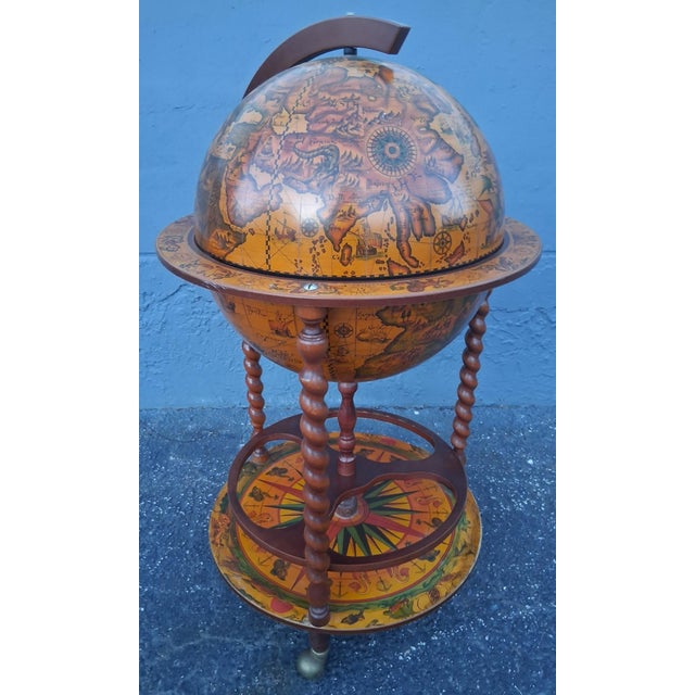 1960's Mid Century World Globe Dry Bar. Stunning and artistic rolling Globe with interior storage.