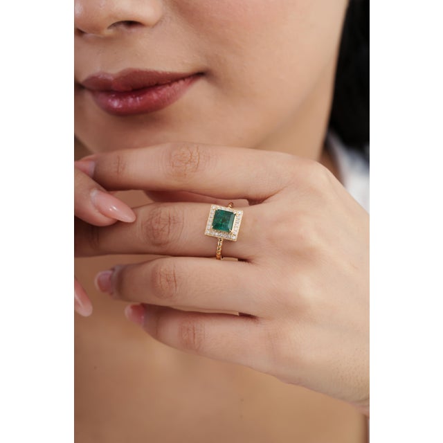 This vintage-style cocktail ring features a 1.88 ct square-cut emerald, set in 14K yellow gold. The center stone measures...