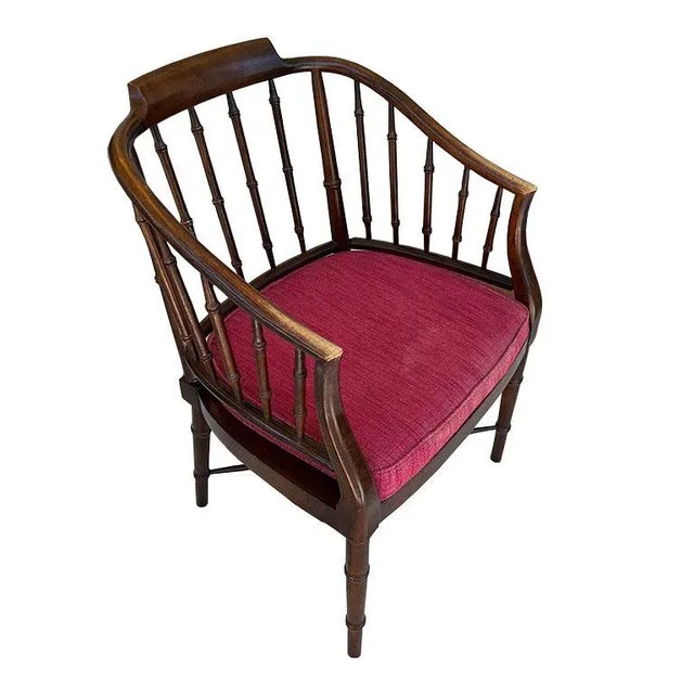 A stunning traditional Chinoiserie Chippendale faux bamboo tub chair in the manner of Baker Furniture Company. This solid...