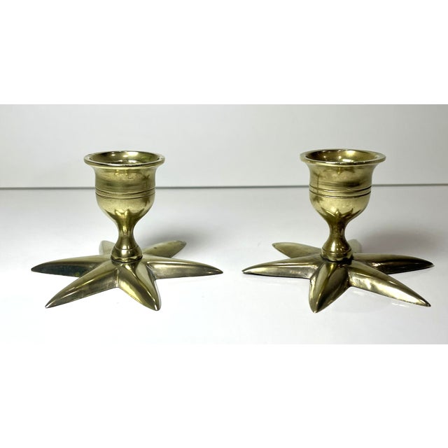 A pair of vintage mid-century modern brass candlestick holders with a star base. Each candlestick weighs 2.7 oz and is...