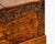 Hand-carved wooden storage chest with intricate dragon and floral motifs across the front panel. This piece is constructed...