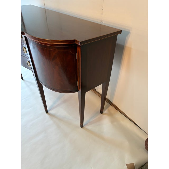 This is a beautiful bench made mahogany sideboard. It has very nice inlays on the top as well as each drawer and cabinet...