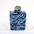 The vintage blue and white floral Chinese snuff bottle with a green stone top is a handmade collectible from China....