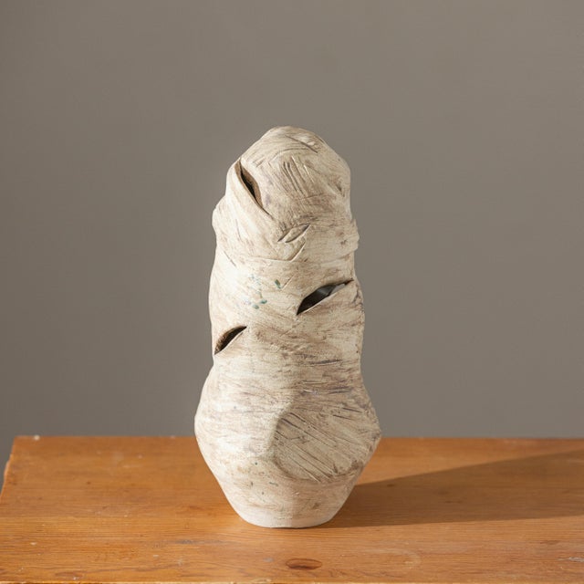Hand-built sculptural studio pottery vase featuring an expressive organic form with asymmetrical openings and a richly...