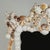 Impressive large scale shell encrusted wall mirror featuring an elaborate architectural frame lavishly adorned with an...