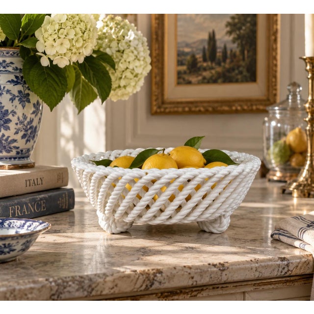 An elegant trompe l'oeil porcelain cachepot crafted in the form of a handwoven rope basket. Executed in glossy white...