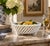 An elegant trompe l'oeil porcelain cachepot crafted in the form of a handwoven rope basket. Executed in glossy white...