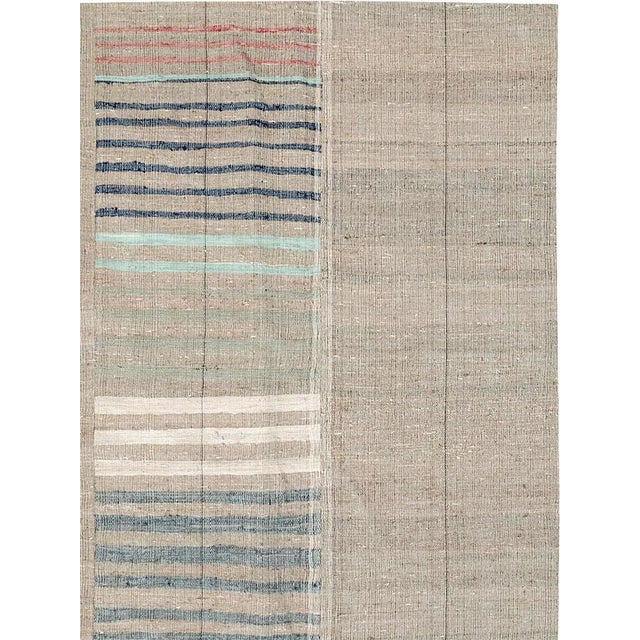 This mid-20th century Turkish Flatweave Kilim rug, presents a beautifully balanced composition of vertical panels, each...