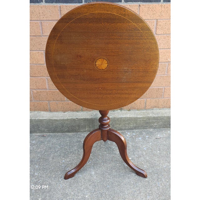 George III Style Satinwood Inlaid Mahogany Tilt Top Candle Stand / Side Table Measures 17" in width, 17" in depth and...