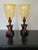 Attractive pair boasting fine carved mahogany bases with large amber glass shades.