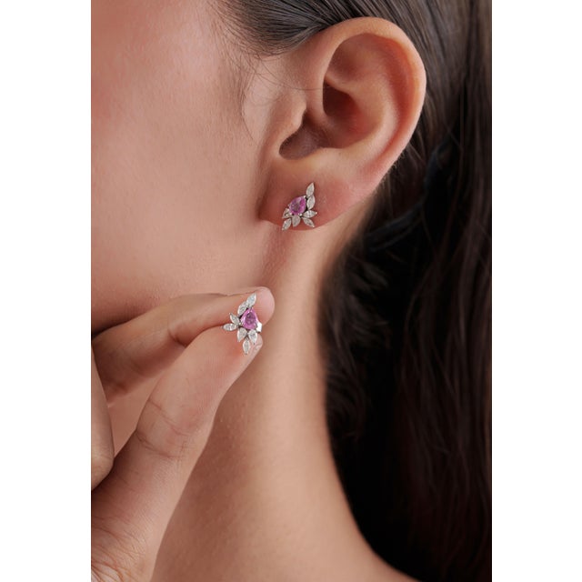 These elegant stud earrings feature a total of 0.57 carats of natural pear-cut pink sapphire, set in 14k white gold. Each...