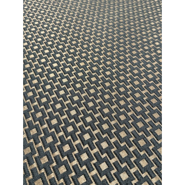 This versatile modern fabric has a raised geometric woven design and a slate and champagne colorway. It’s a hand is...