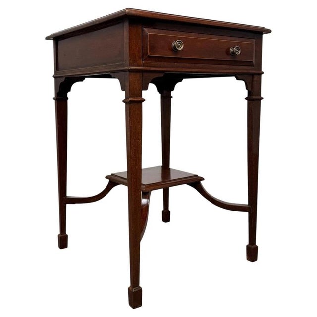 An elegant early 20th-century English Edwardian side table, finely crafted from mahogany and distinguished by its...