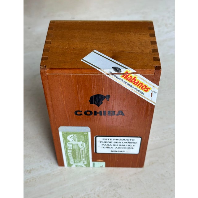 An empty Cohiba box with dove-tailed edges and the original information wrappers inside as shown in pictures. It smells...